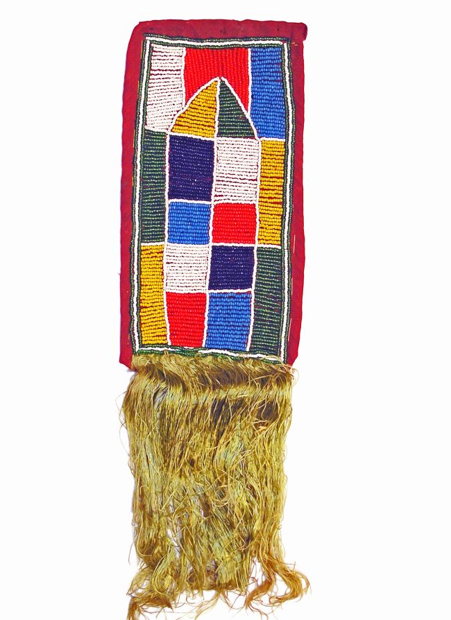 Rectangular beadwork in grey, light blue, dark blue, red and yellow design. The at has tassles at one end.