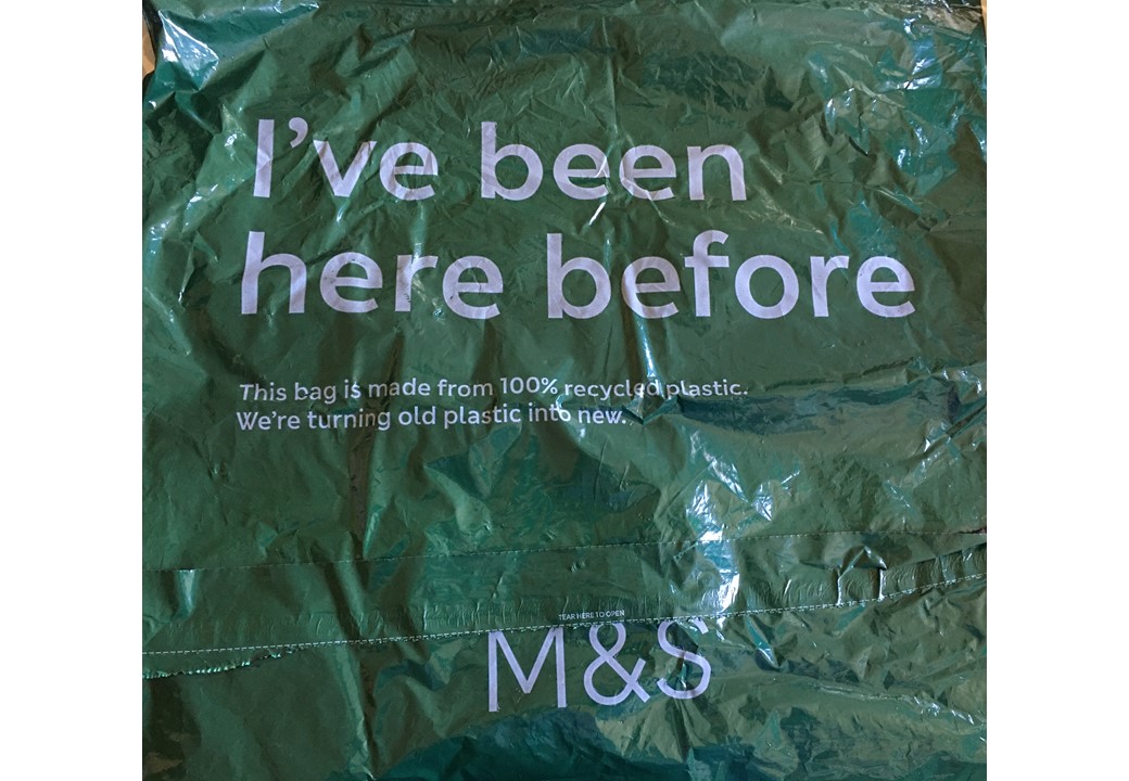 Colour photograph showing part of a plastic bag . Writing on it says 'I've been here before'.